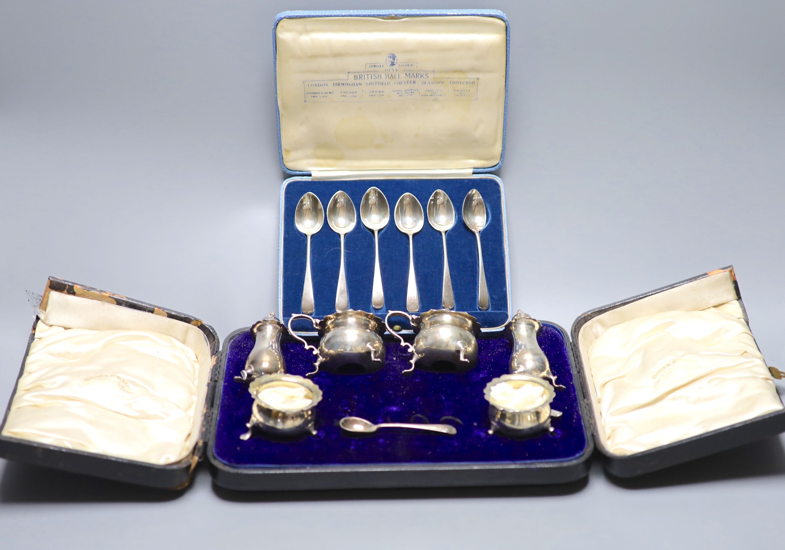 A cased set set of six 'British Hallmark' teaspoons and a cased part silver condiment set.